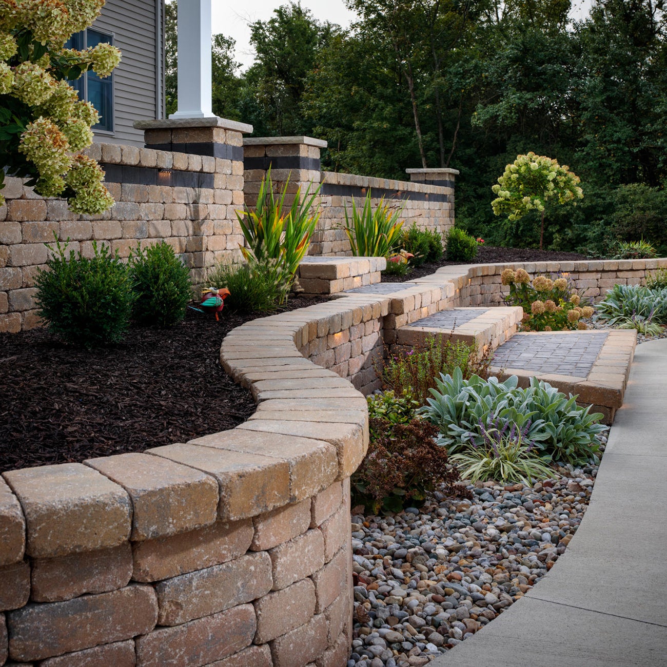 A home gardener adding pops of color with vibrant blooms in a lush garden bed.